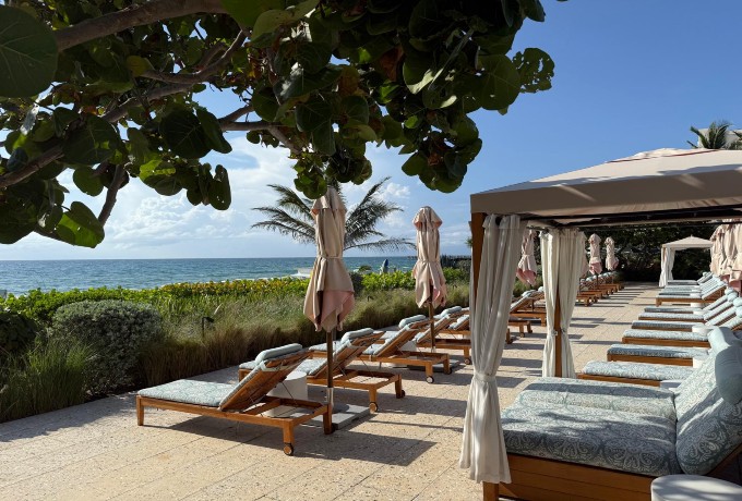 Lounger at Four Seasons Resort Palm Beach with the beach and ocean in the background, ideal for relaxing and recharging