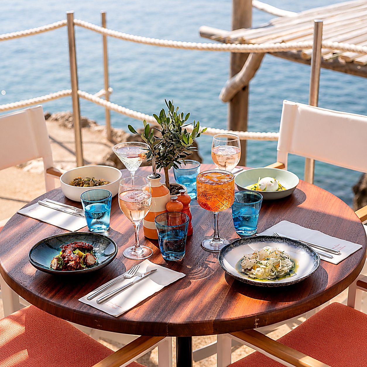 Seaside dining table for Maybourne Illustrated hotel benefits