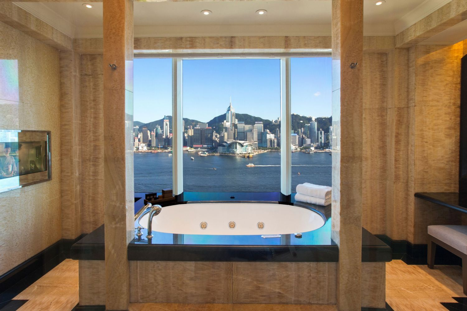 Harbour view bathroom at The Peninsula Hong Kong overlooking Victoria Harbour and the Hong Kong skyline.