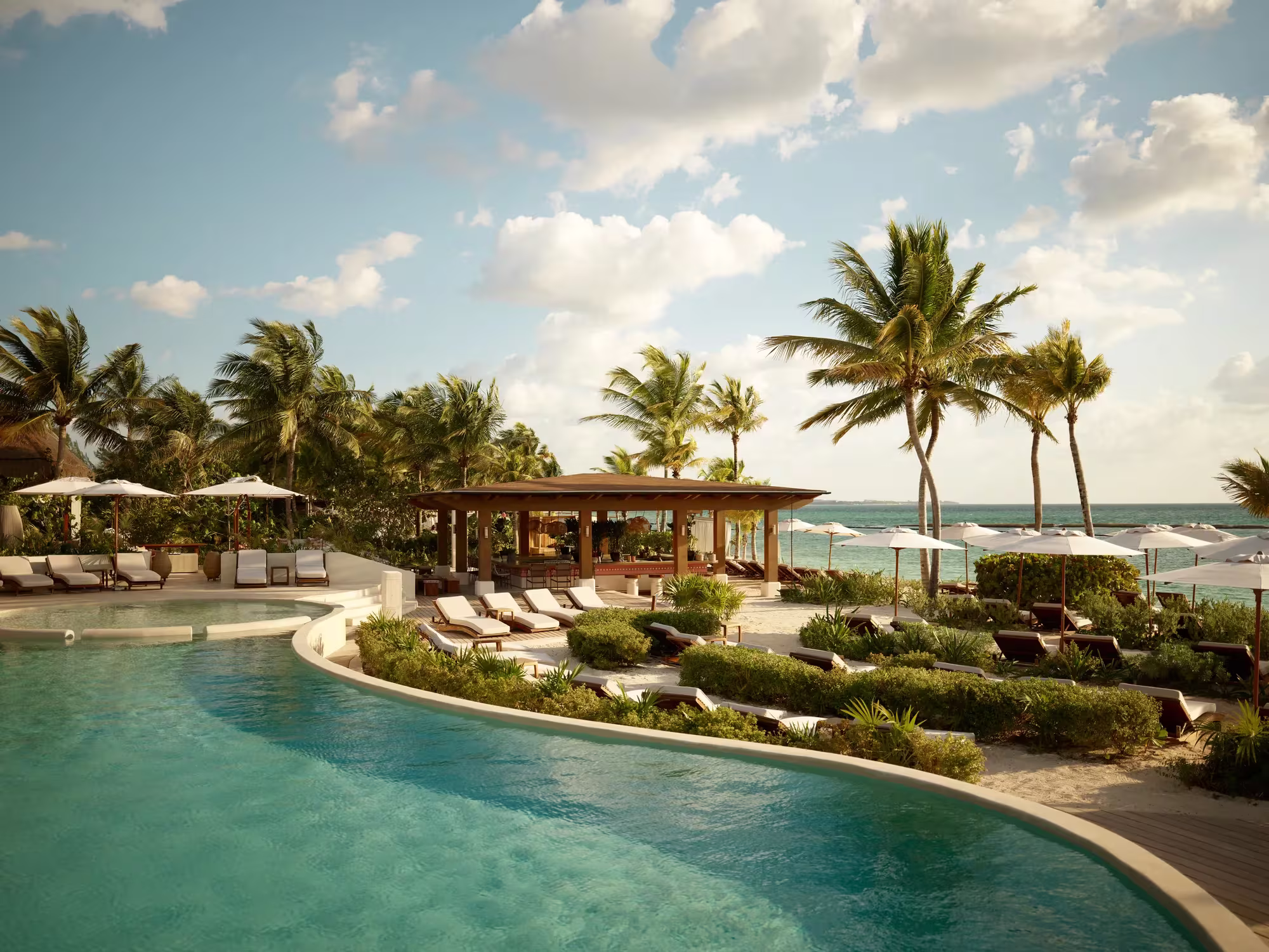Luxury beachfront pool at a participating Rosewood resort featured in the More Rosewood complimentary night offer.