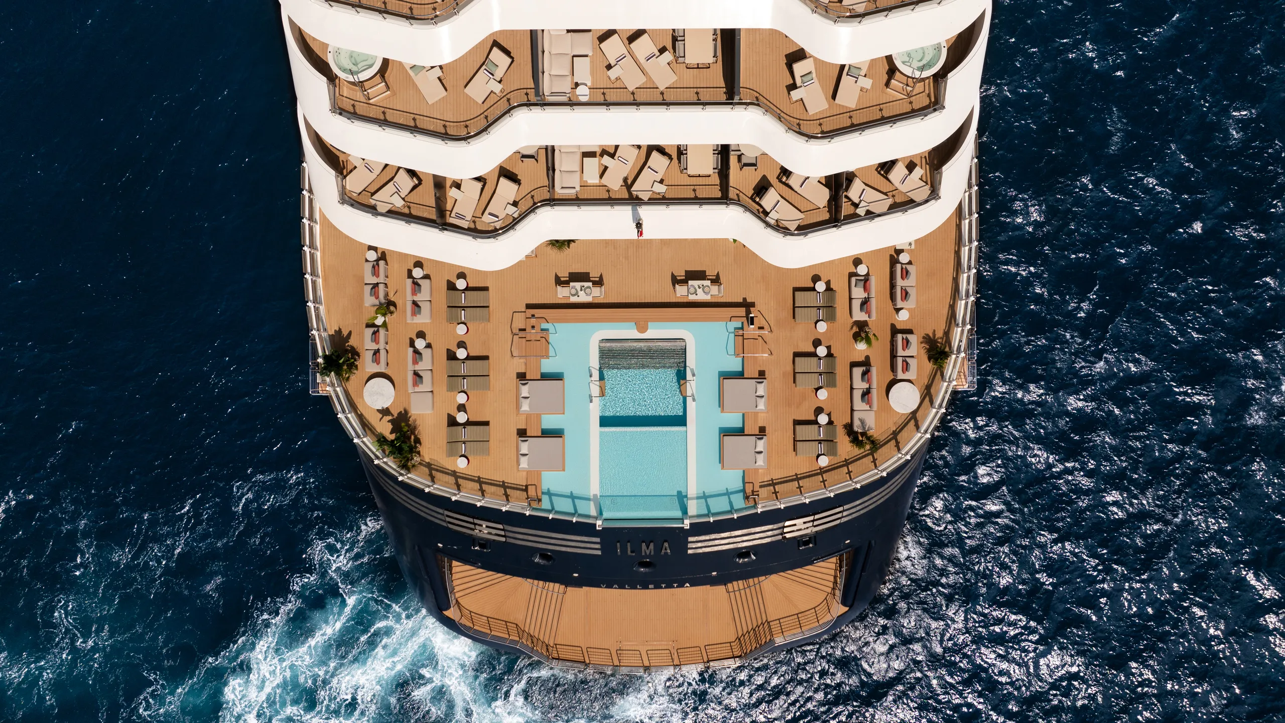 Aerial view of The Ritz-Carlton Yacht Collection with an infinity pool and sun deck, featured in the USD 300 onboard credit offer.