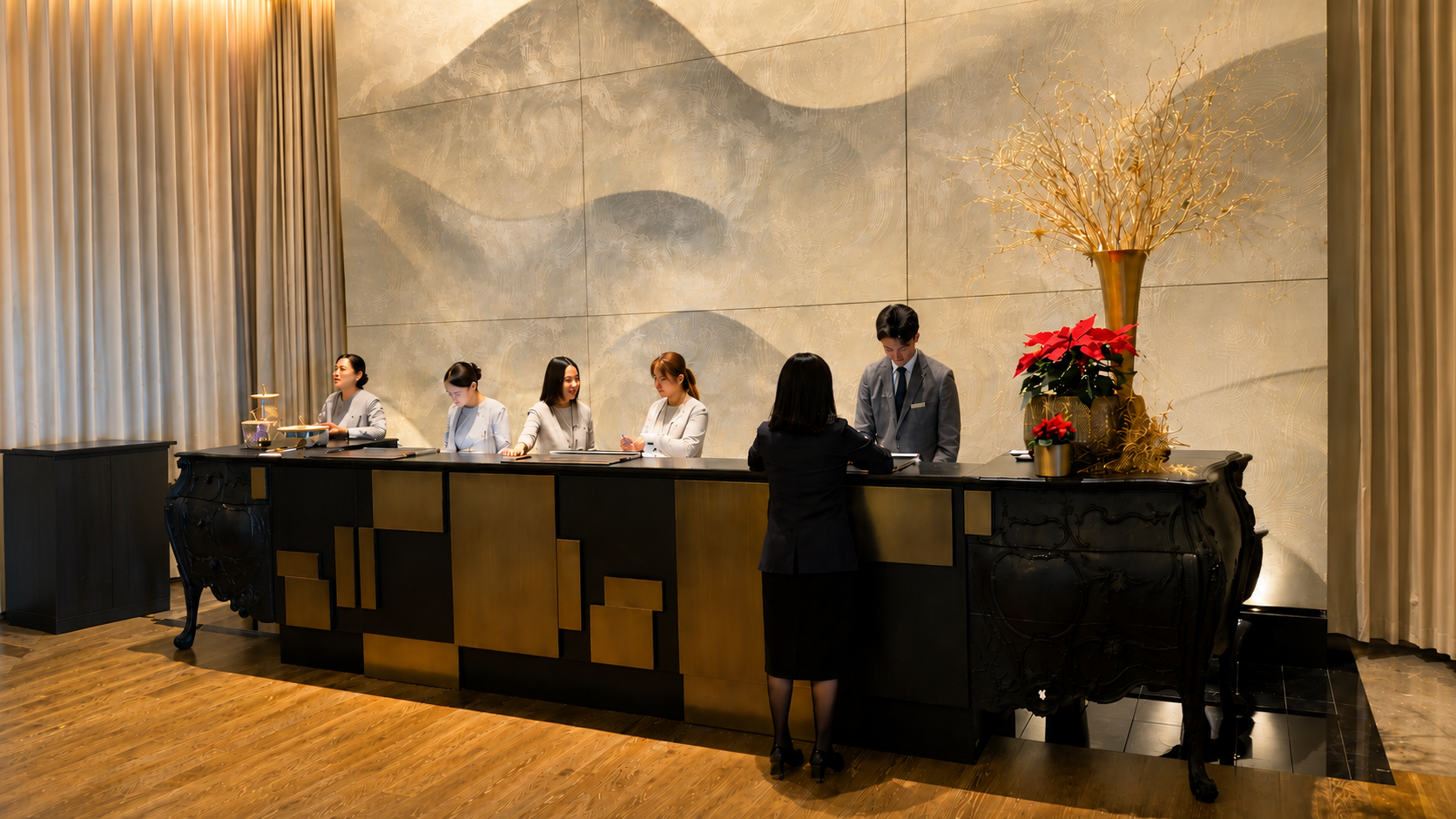 Reception area at Four Seasons Hotel Tokyo at Otemachi with front desk staff assisting guests in a contemporary luxury lobby.