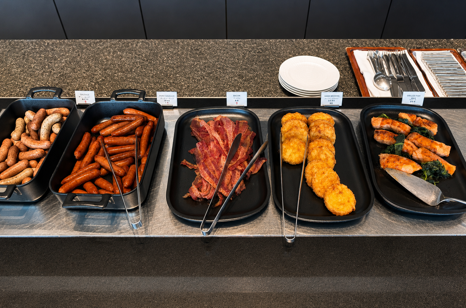 Hot breakfast buffet featuring sausages, bacon, hash browns and grilled fish at Pigneto at Four Seasons Hotel Tokyo at Otemachi.