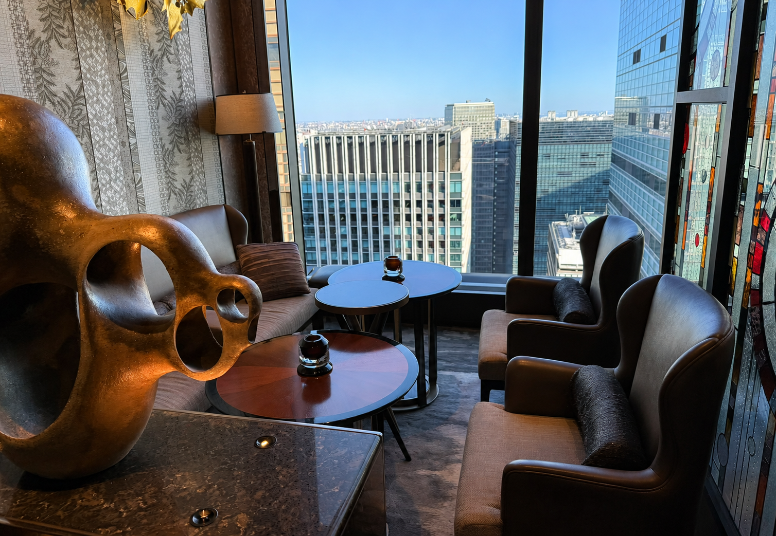 Private seating area at The Lounge in Four Seasons Hotel Tokyo at Otemachi with city views through floor-to-ceiling windows.