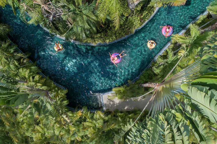 Aerial view of the lazy river pool at Four Seasons Resort Punta Mita surrounded by tropical gardens