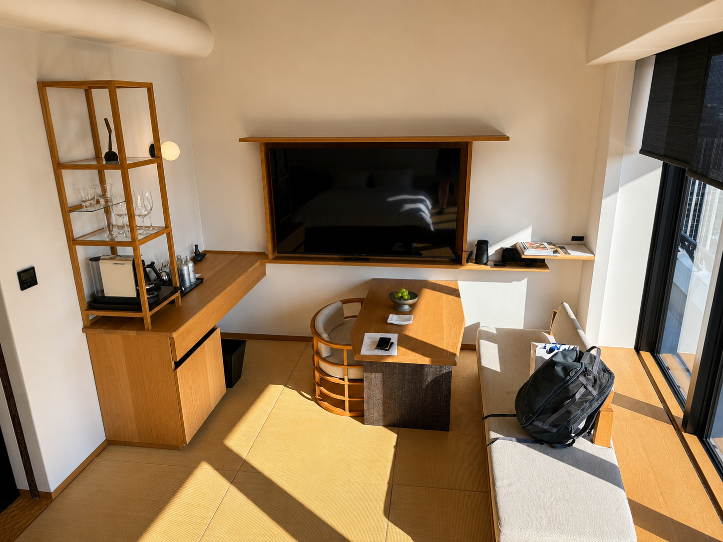 Living area of the Tatami Suite at Four Seasons Osaka with tatami flooring, dining table, sofa, coffee station, and floor-to-ceiling windows.
