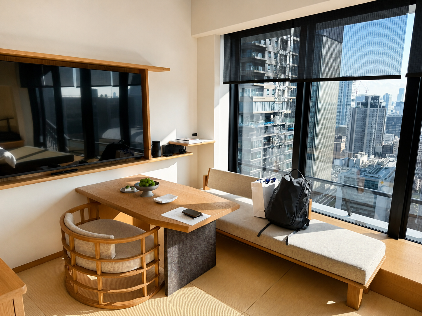Living area of the Tatami Suite at Four Seasons Osaka with dining table, window seating, tatami flooring, and views across Osaka.
