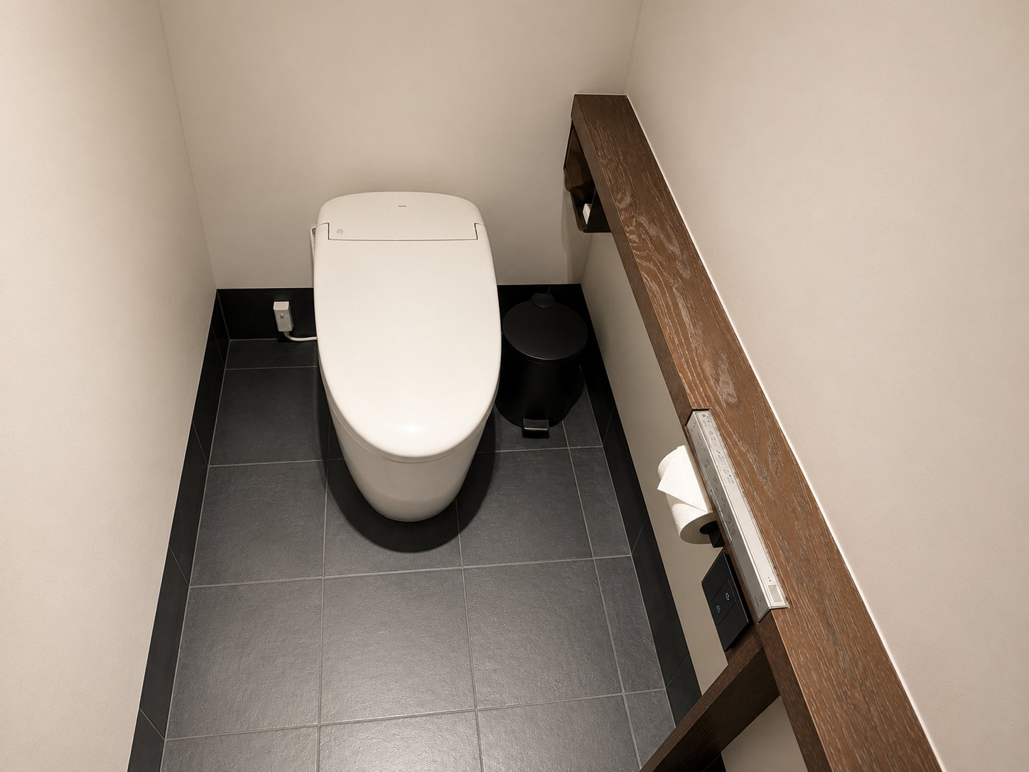 Toto smart toilet in a Gensui guest room at Four Seasons Osaka with Japanese bidet controls and minimalist design.