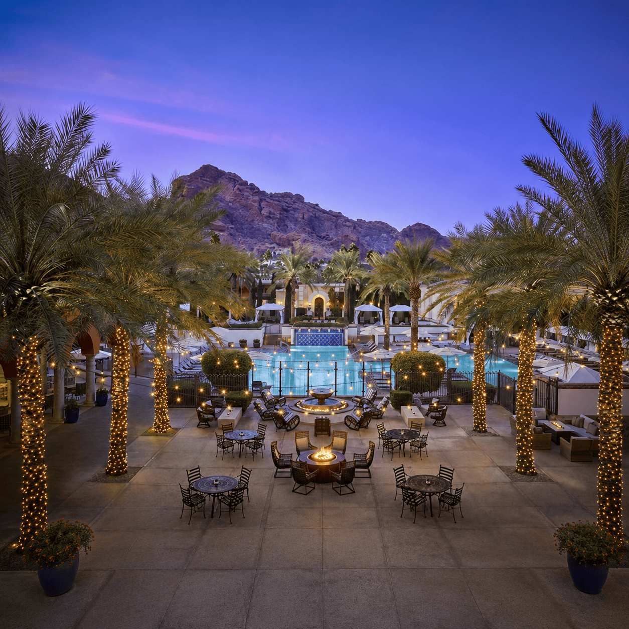 Omni Select luxury hotel courtyard with illuminated pool at dusk