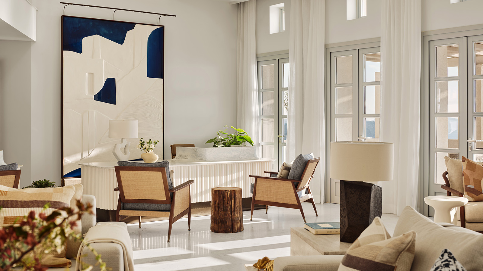 Lobby lounge at Four Seasons Resort Mykonos with contemporary Cycladic interiors, high ceilings and relaxed seating areas.