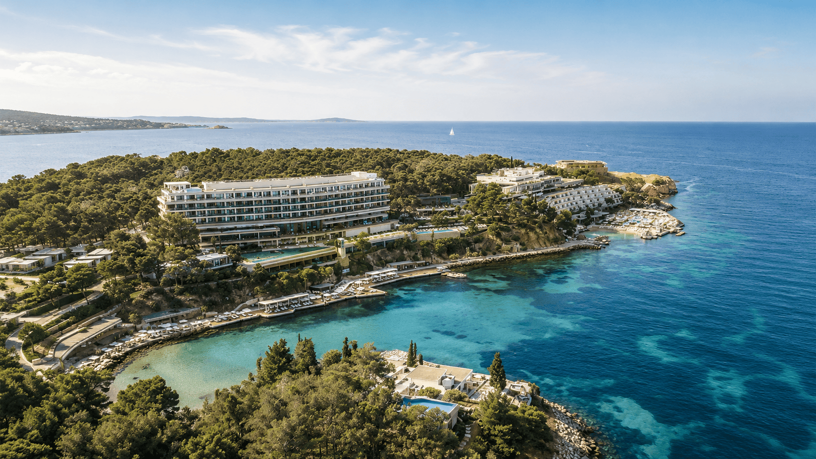Aerial view of Four Seasons Astir Palace Hotel Athens on the Athens Riviera, with private beaches and clear Aegean waters.