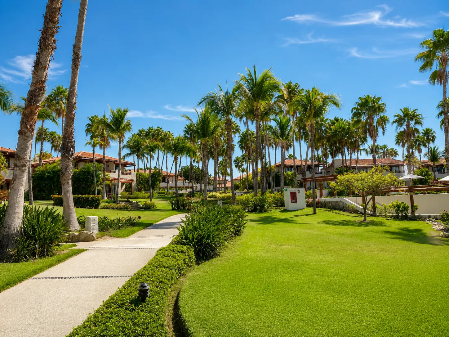 Manicured gardens, palm trees and casita buildings at The St. Regis Punta Mita.
