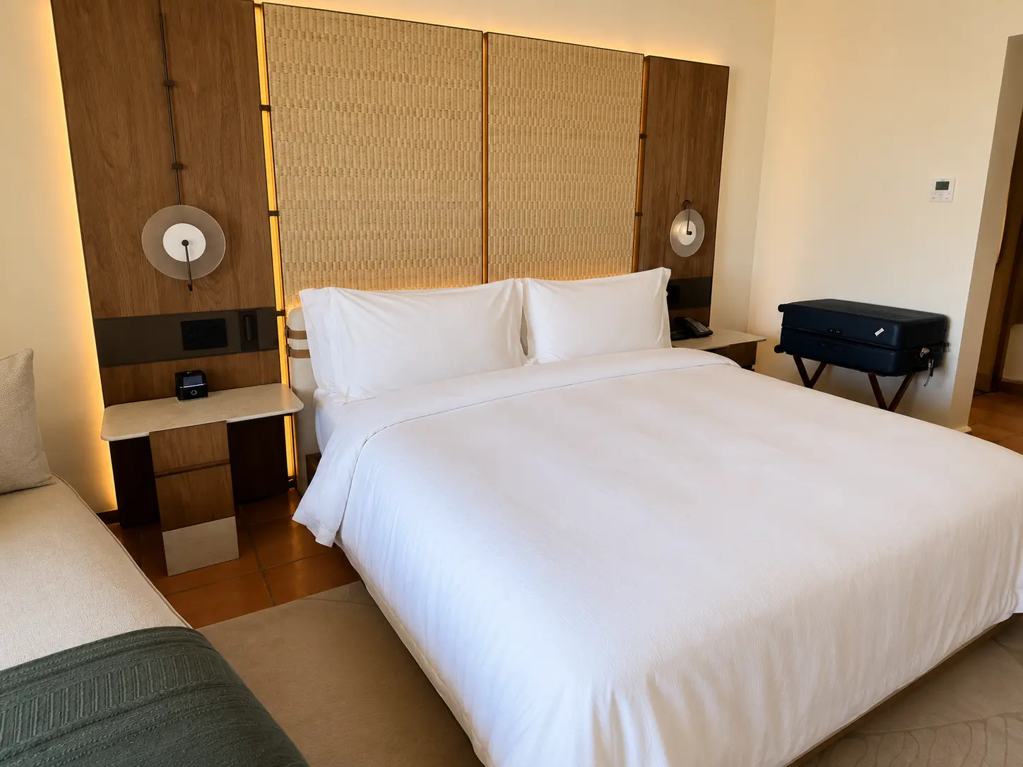 King bed and woven headboard inside a renovated Ocean View Casita at The St. Regis Punta Mita.