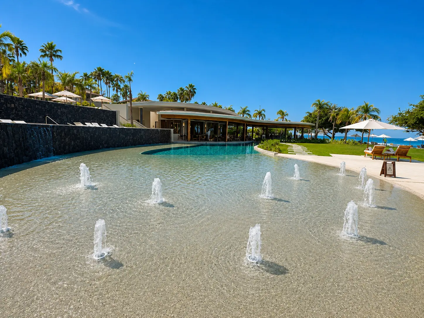 The family pool at The St. Regis Punta Mita featuring a shallow splash area with water jets for young children.