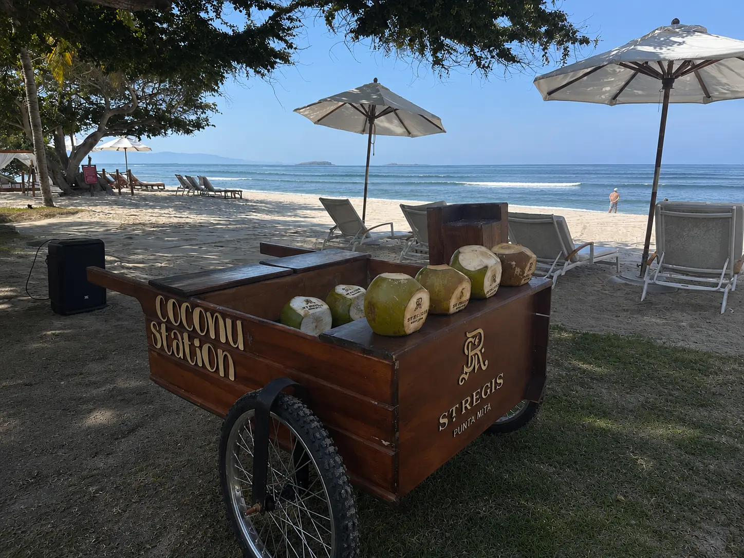 Coconut station on the beach at The St. Regis Punta Mita with loungers, umbrellas and Pacific Ocean views.