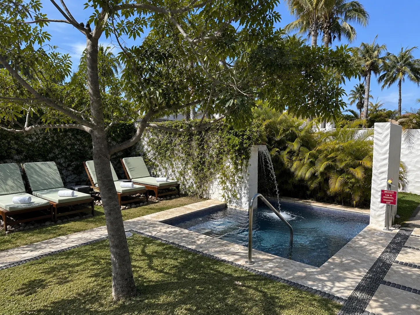 Outdoor plunge pool and relaxation loungers at Remède Spa in The St. Regis Punta Mita surrounded by tropical gardens.