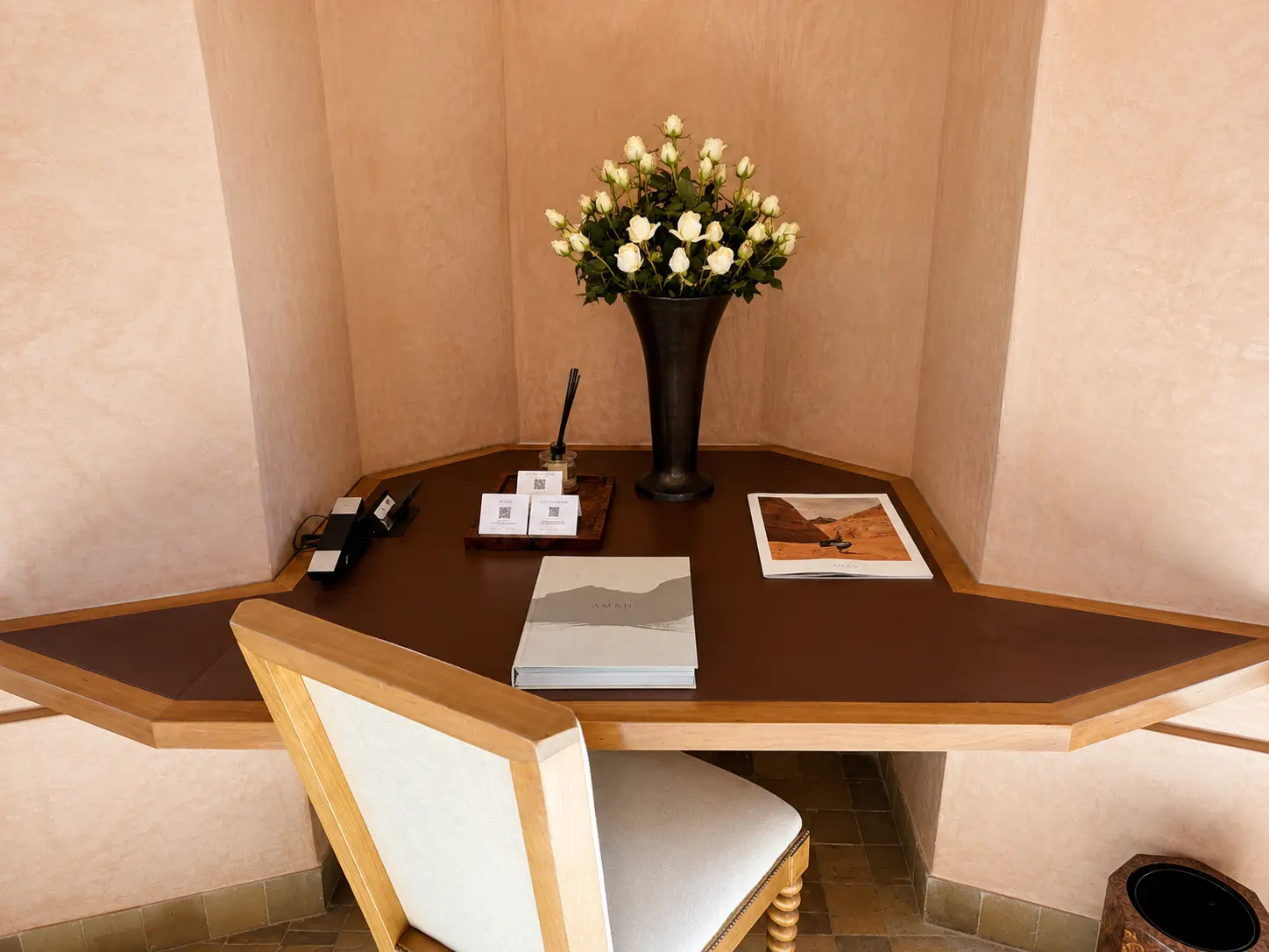 Writing desk inside a Deluxe Pavilion at Amanjena Marrakech with handcrafted furnishings and Moroccan plaster walls.
