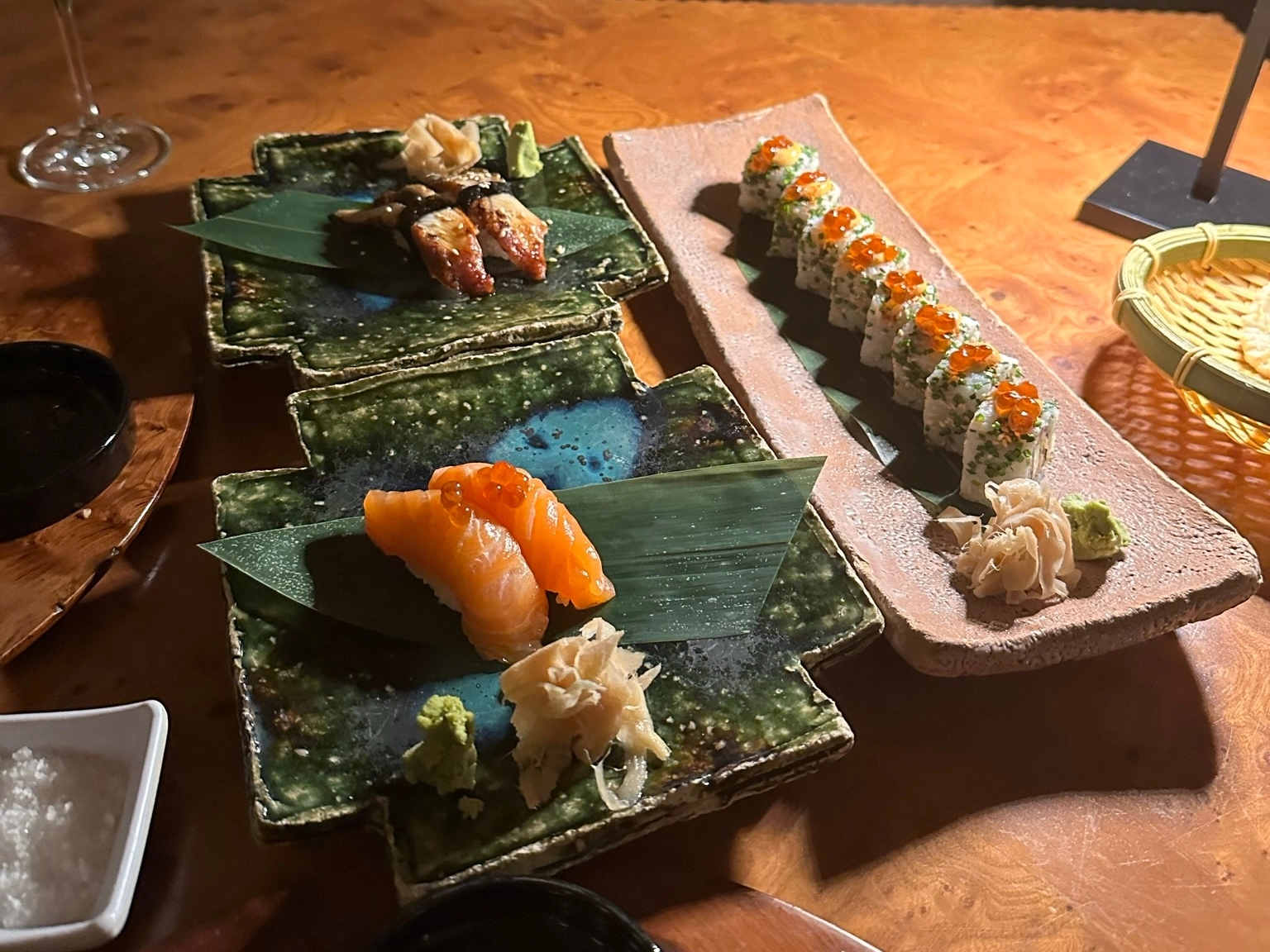 Assorted sushi and nigiri served at Nama restaurant at Amanjena in Marrakech, featuring salmon nigiri, glazed eel nigiri, sushi rolls with salmon roe, and traditional Japanese presentation.