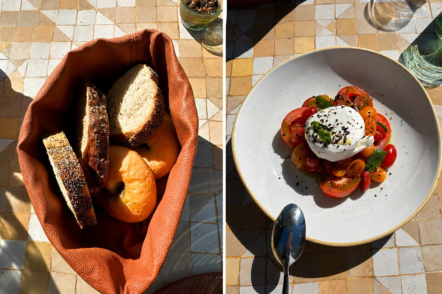 Fresh bread basket and burrata tomato salad served for lunch in Amanjena's Olive Grove, Marrakech, with outdoor garden dining beneath mature olive trees.