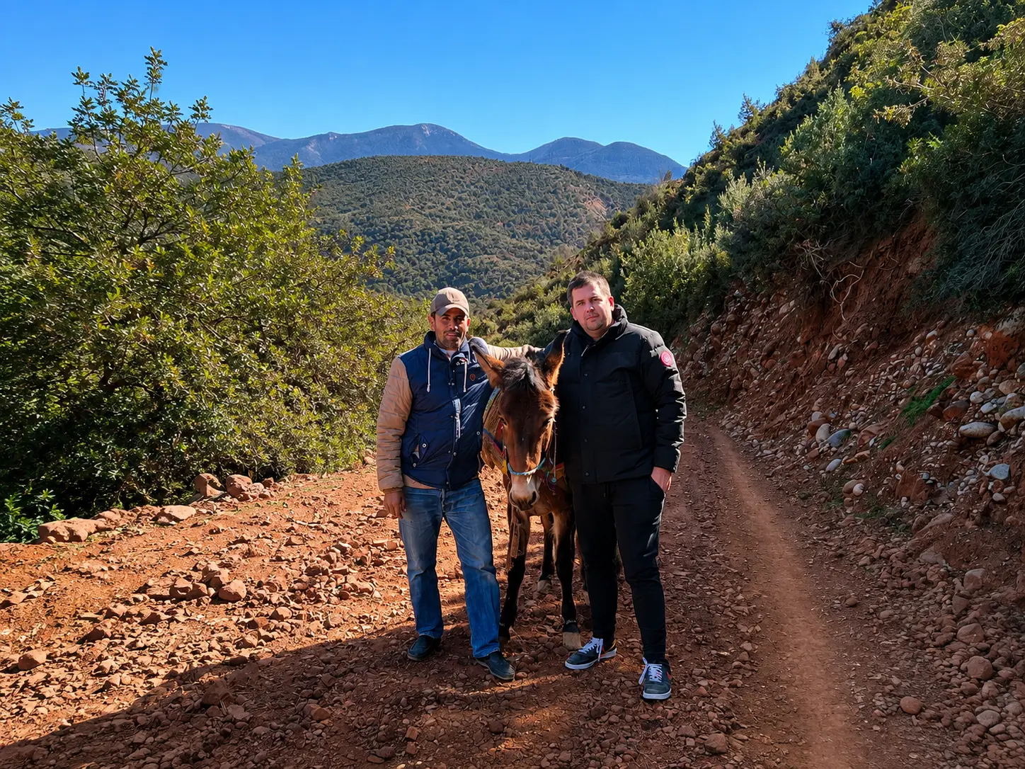 Dylan Clements, founder of Clements Travel meeting a local Amazigh family and their donkey during an Aman Experience in the Atlas Mountains near Amanjena, Marrakech, Morocco.