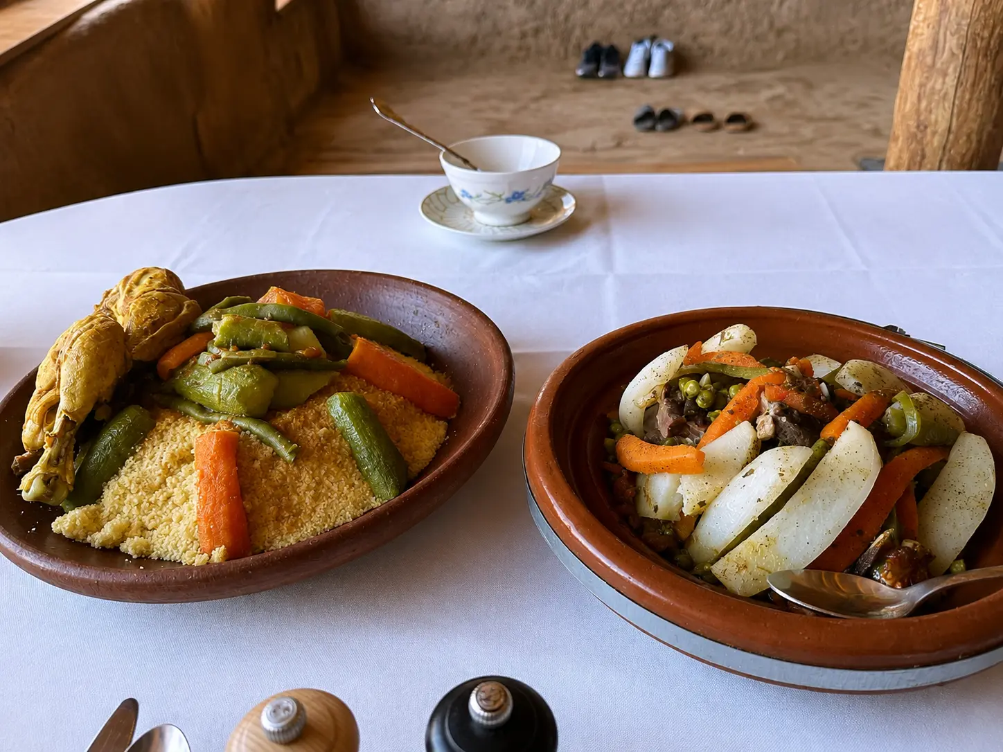 Traditional Moroccan chicken couscous and beef tagine served during a Berber lunch in the Atlas Mountains near Marrakech.