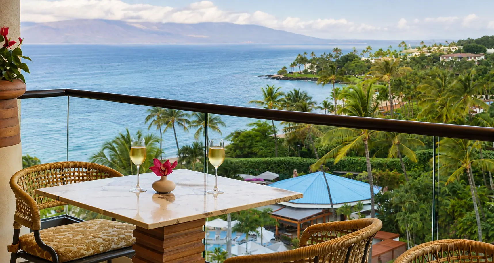 Ocean view from a private balcony at Four Seasons Resort Maui at Wailea overlooking palm trees, the Pacific Ocean, and the island of Lanai.