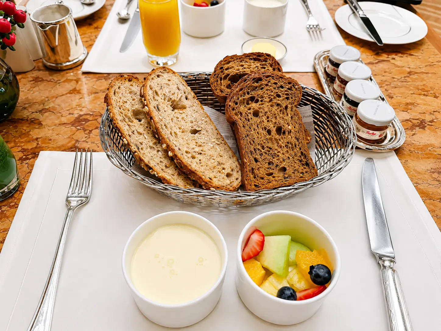À la carte breakfast at The Lobby at The Peninsula Tokyo with fresh fruit, bread, yogurt and orange juice.Caption: