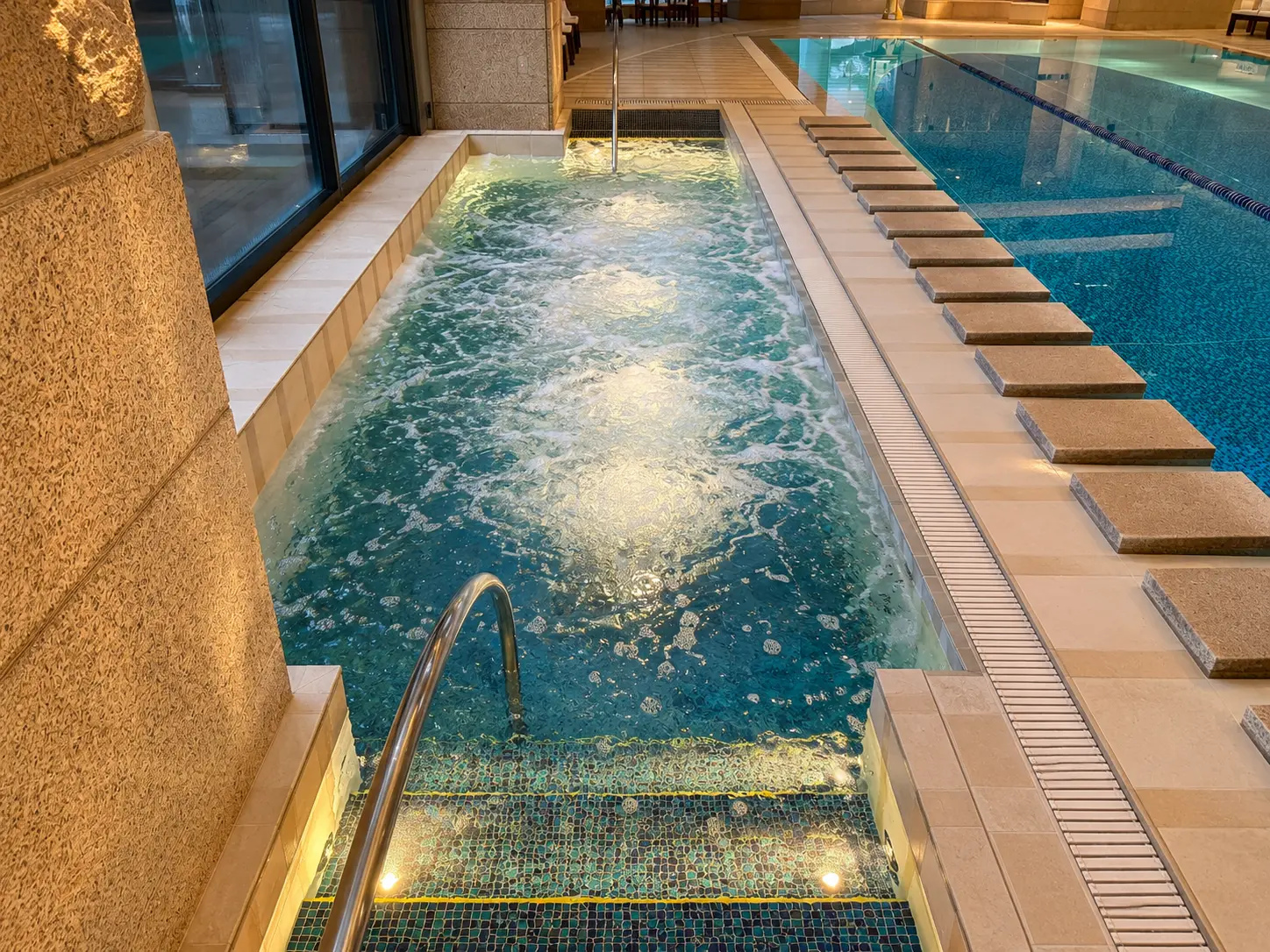 Jacuzzi and hydrotherapy pool beside the indoor swimming pool at The Peninsula Tokyo spa.