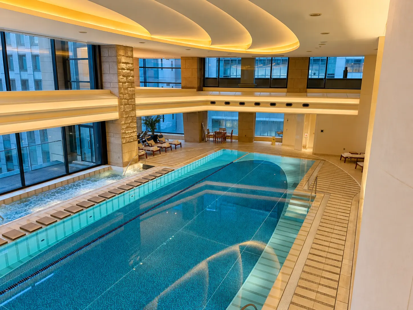 Indoor swimming pool and spa facilities at The Peninsula Tokyo with a lap pool and Jacuzzi.