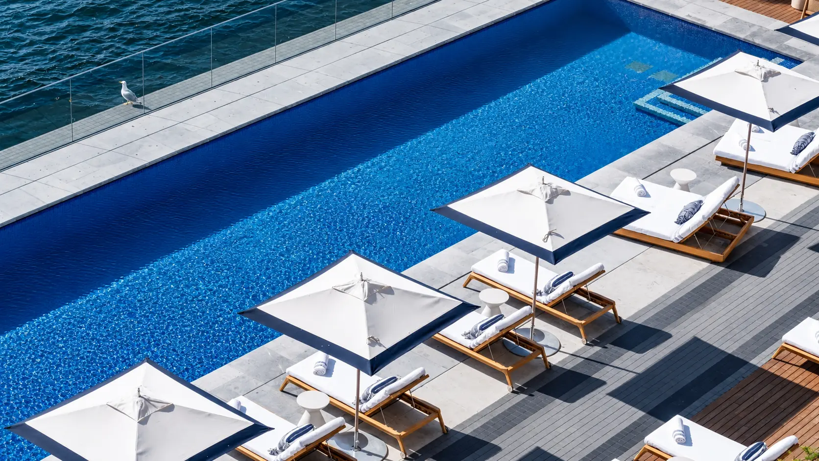 The pool at a Peninsula hotel, featured in our guide to Peninsula Time and PenClub, including flexible check-in and check-out and additional benefits available through PenClub bookings.