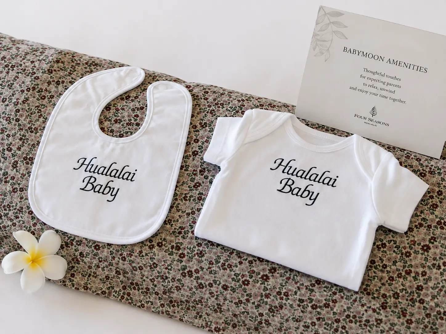 Hualalai Baby bodysuit and bib provided by Four Seasons Hualalai for Clements Travel clients staying at the resort for their babymoon.
