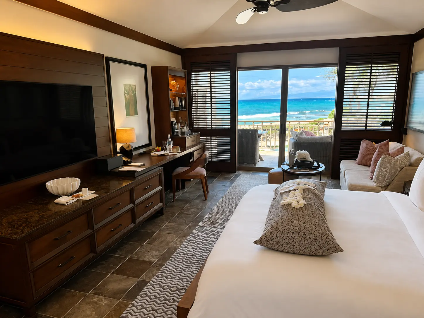 Four Seasons Hualalai guest room prepared for a babymoon with a maternity pillow on the bed for a Clements Travel client.