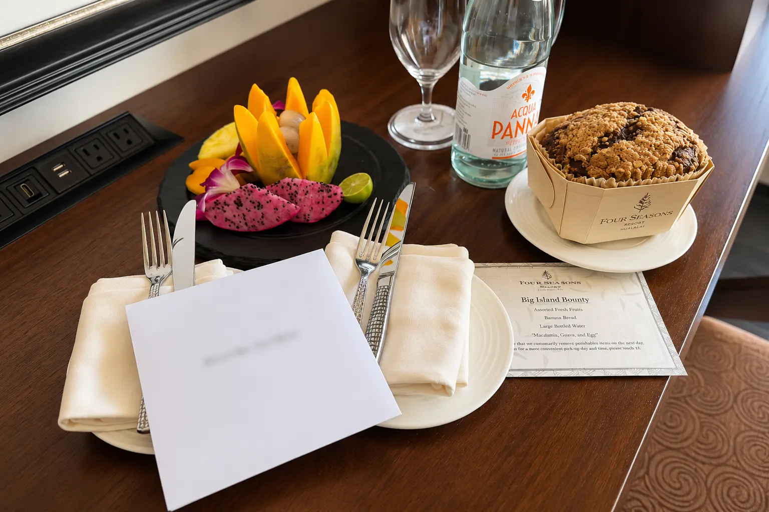 Four Seasons Hualalai Big Island Bounty welcome amenity with tropical fruit, banana bread and bottled water for Clements Travel clients.