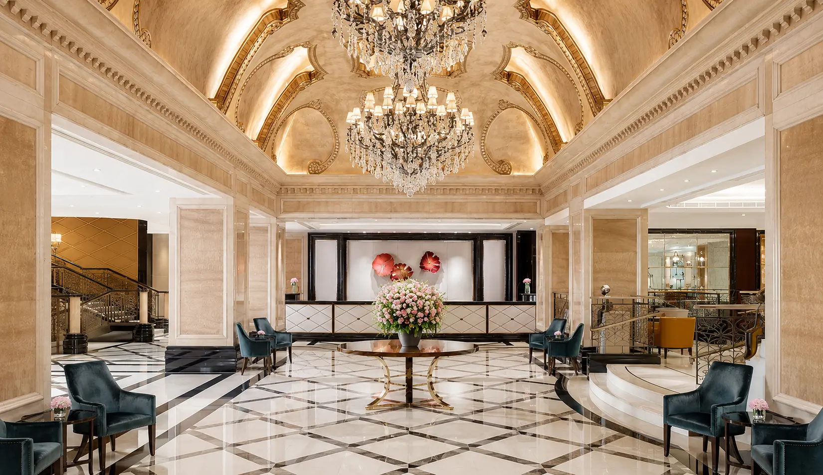 Luxury Langham hotel lobby with chandeliers, marble floors and reception area