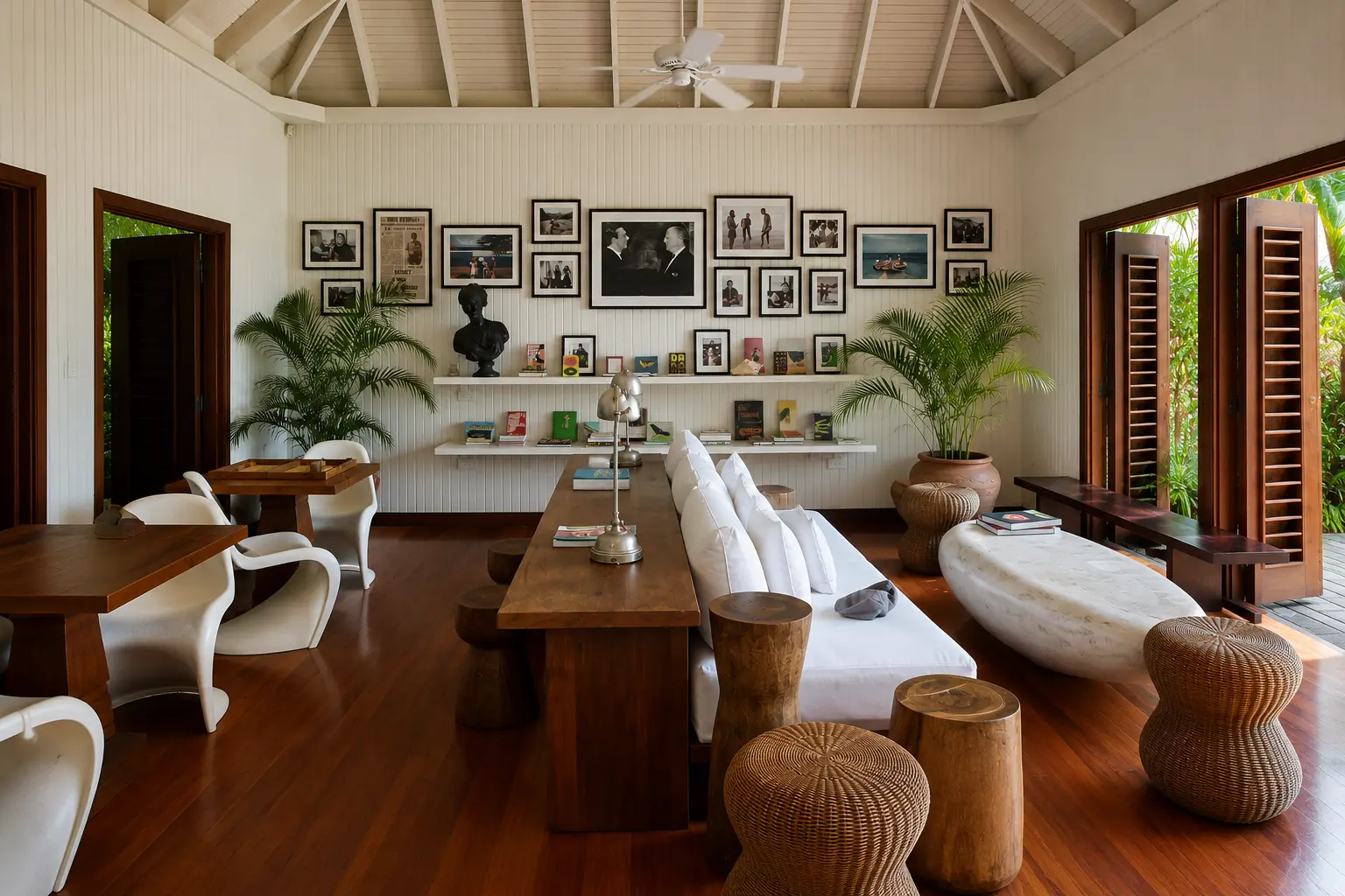 Fleming Room reception at GoldenEye Jamaica with historic photographs, books, timber furniture and tropical gardens.