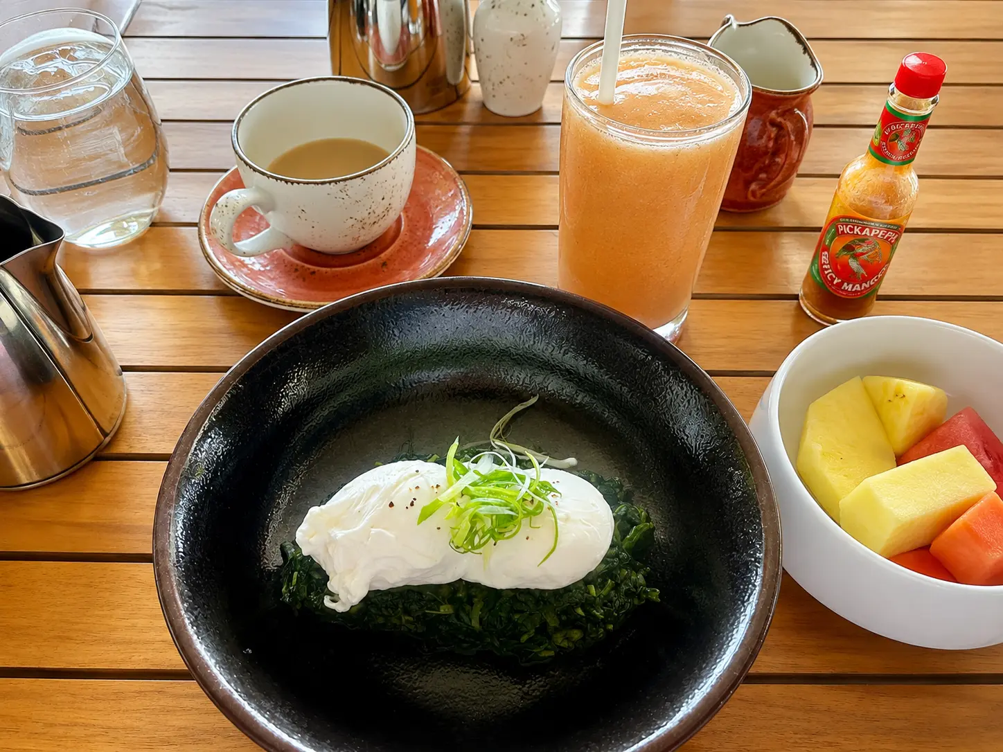 Breakfast at GoldenEye Jamaica with poached eggs, callaloo, tropical fruit, fresh juice and coffee.