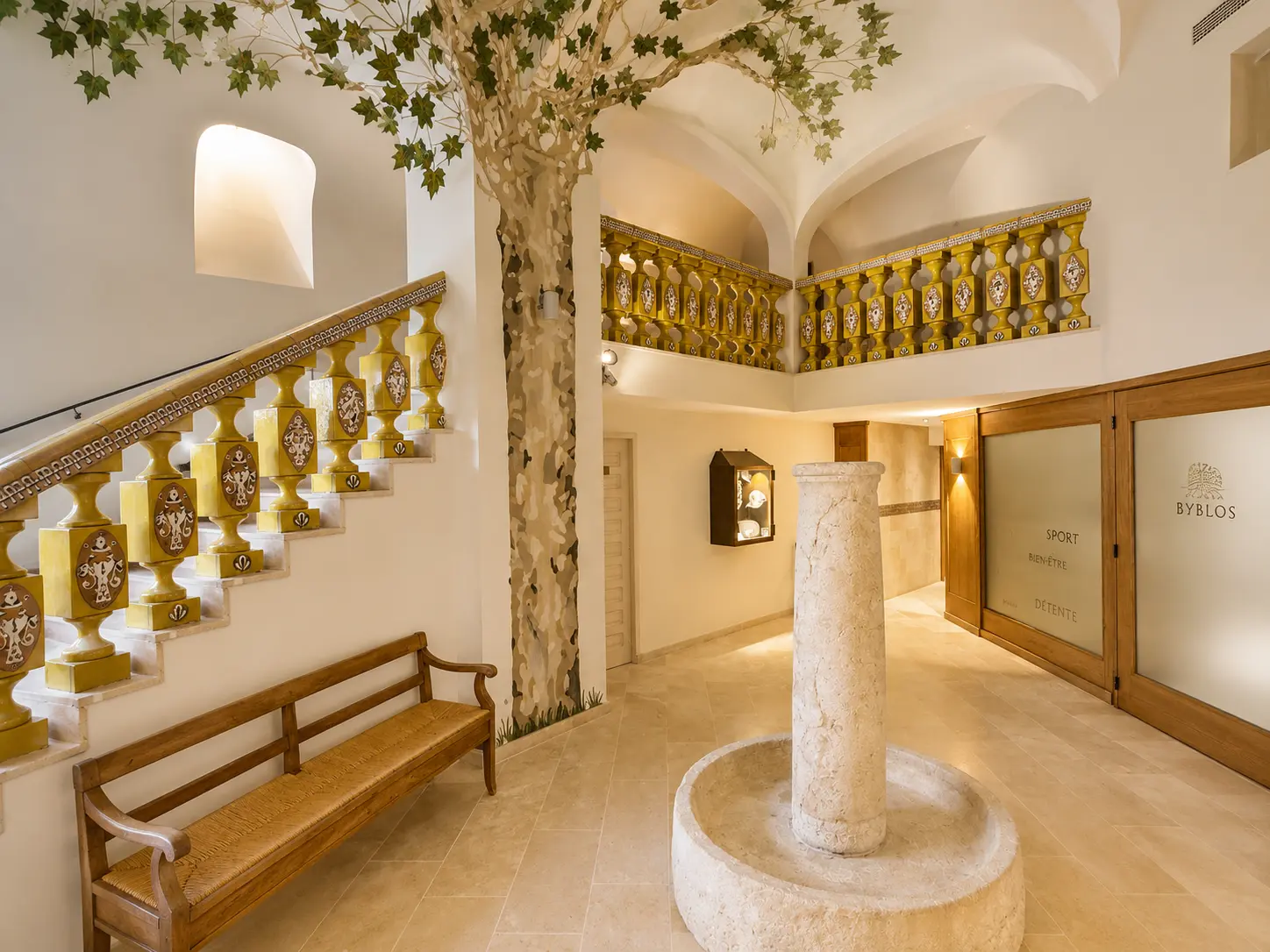 Byblos Saint-Tropez public area with decorative stonework, staircase and Mediterranean interior design