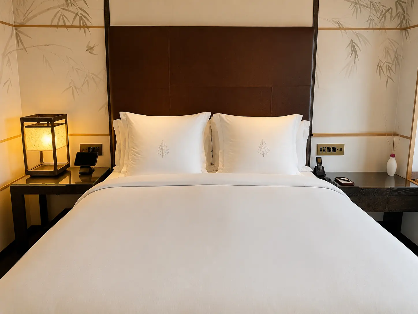 Contemporary guest room at Four Seasons Hotel Kyoto with warm timber finishes and Japanese-inspired design.