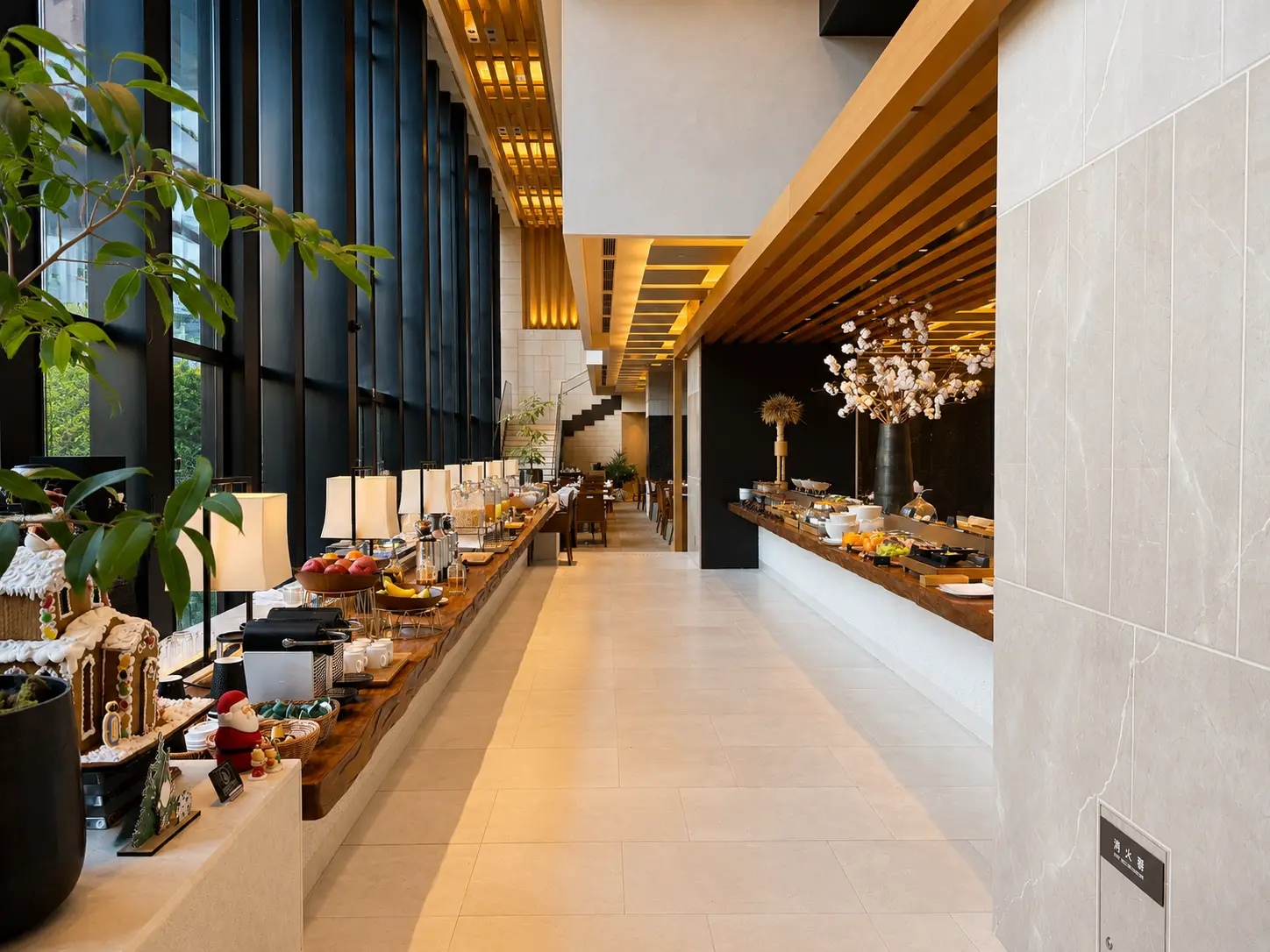 Breakfast buffet inside EMBA Kyoto Grill at Four Seasons Hotel Kyoto with fruit, pastries, hot dishes and seasonal decorations.