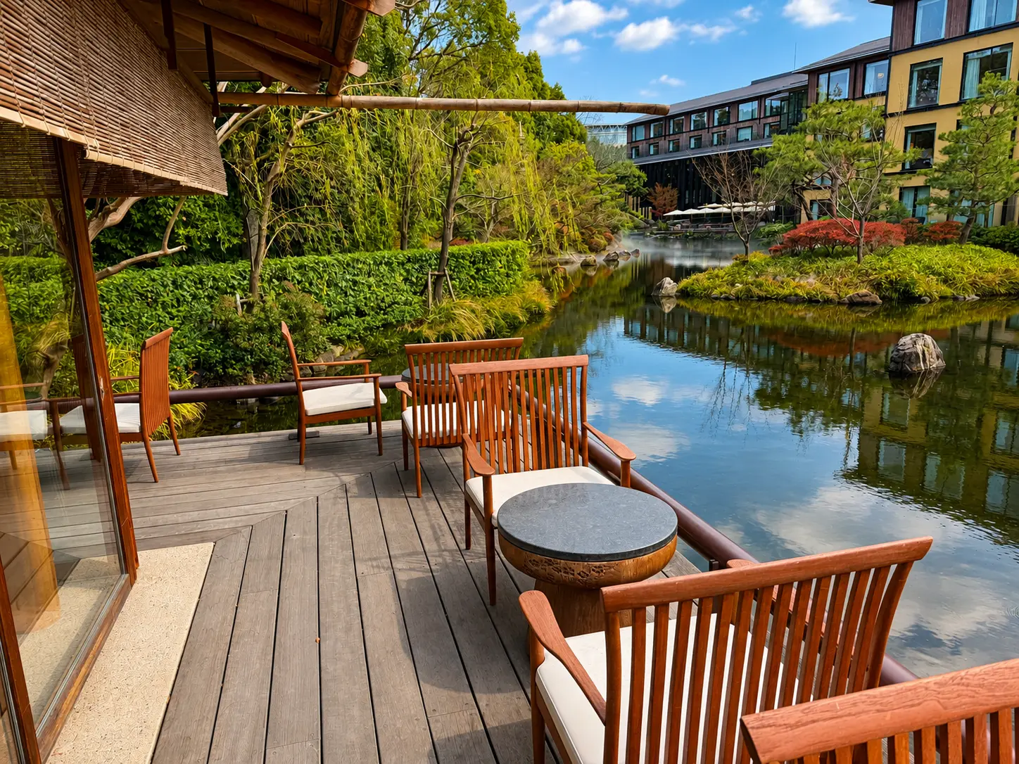 Outdoor terrace at FUJU Tea House overlooking the Shakusui-en pond at Four Seasons Hotel Kyoto.