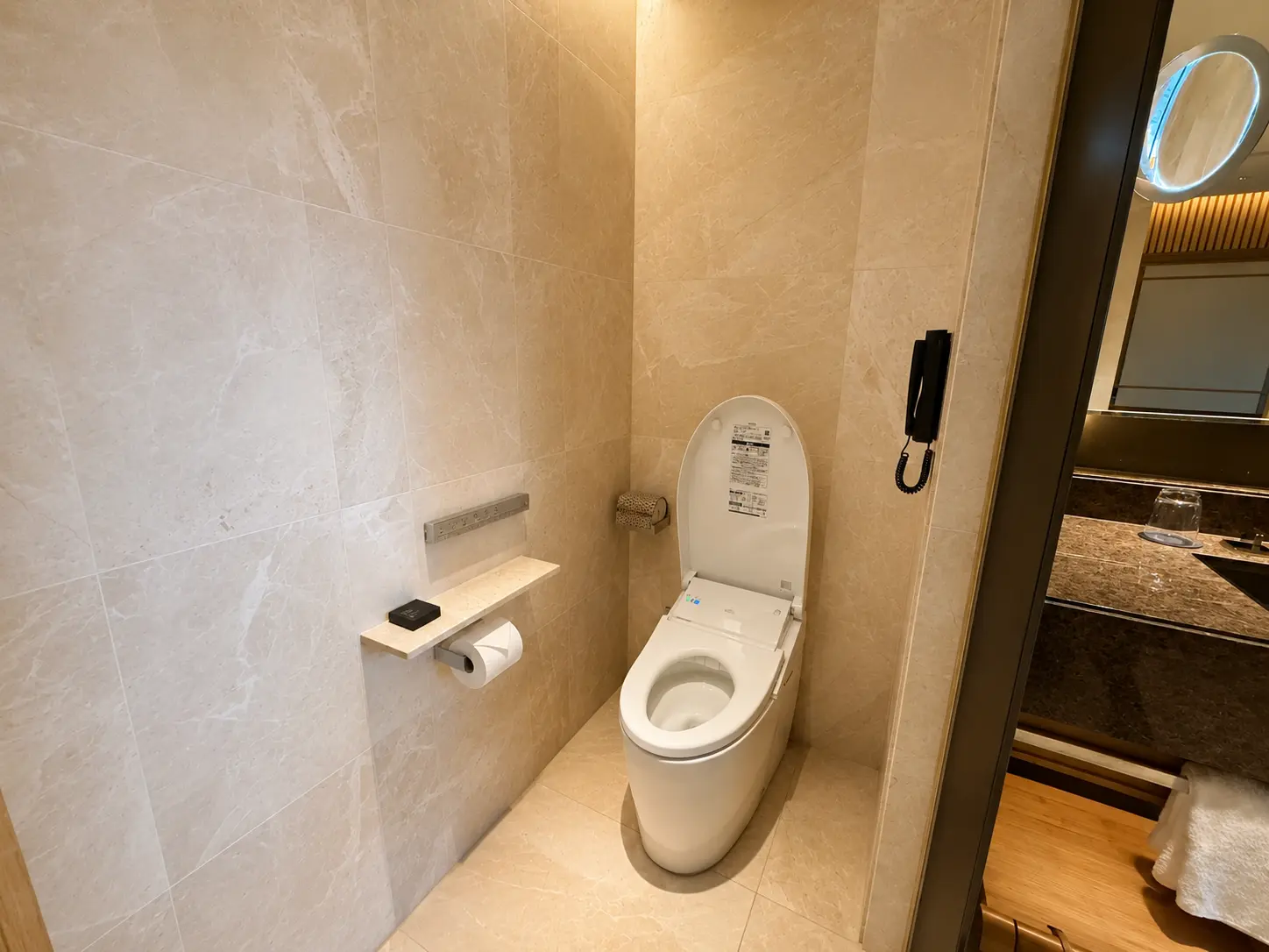 Separate Japanese washlet toilet room in a Deluxe Room at Four Seasons Hotel Kyoto.