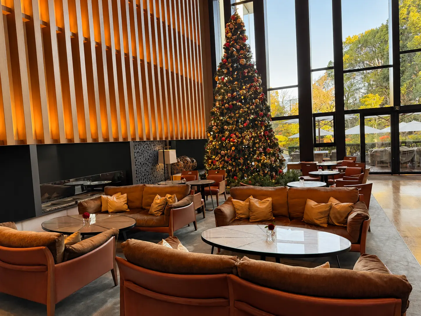 Lounge seating and Christmas tree inside EMBA Kyoto Grill at Four Seasons Hotel Kyoto.