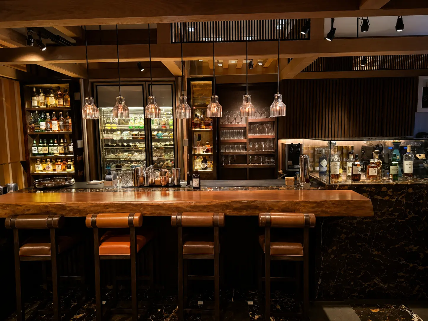 SEY Bar at Four Seasons Hotel Kyoto with timber bar counter, whisky display and Japanese spirits.