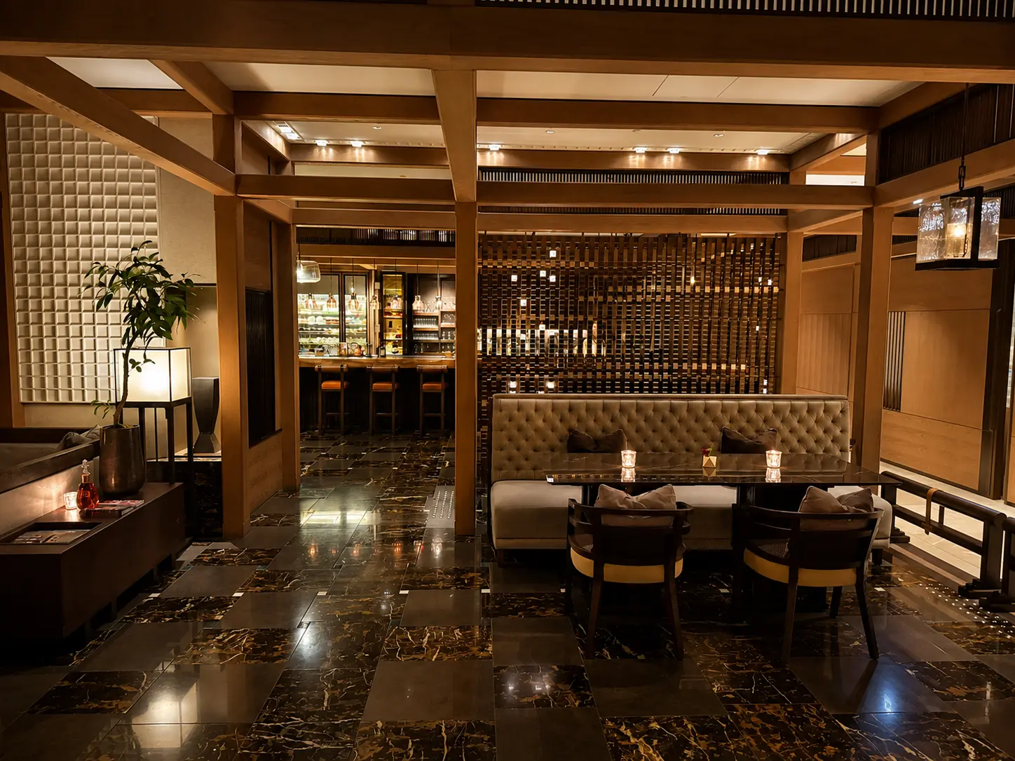 Lounge seating inside SEY Bar at Four Seasons Hotel Kyoto with timber interiors and intimate tables.