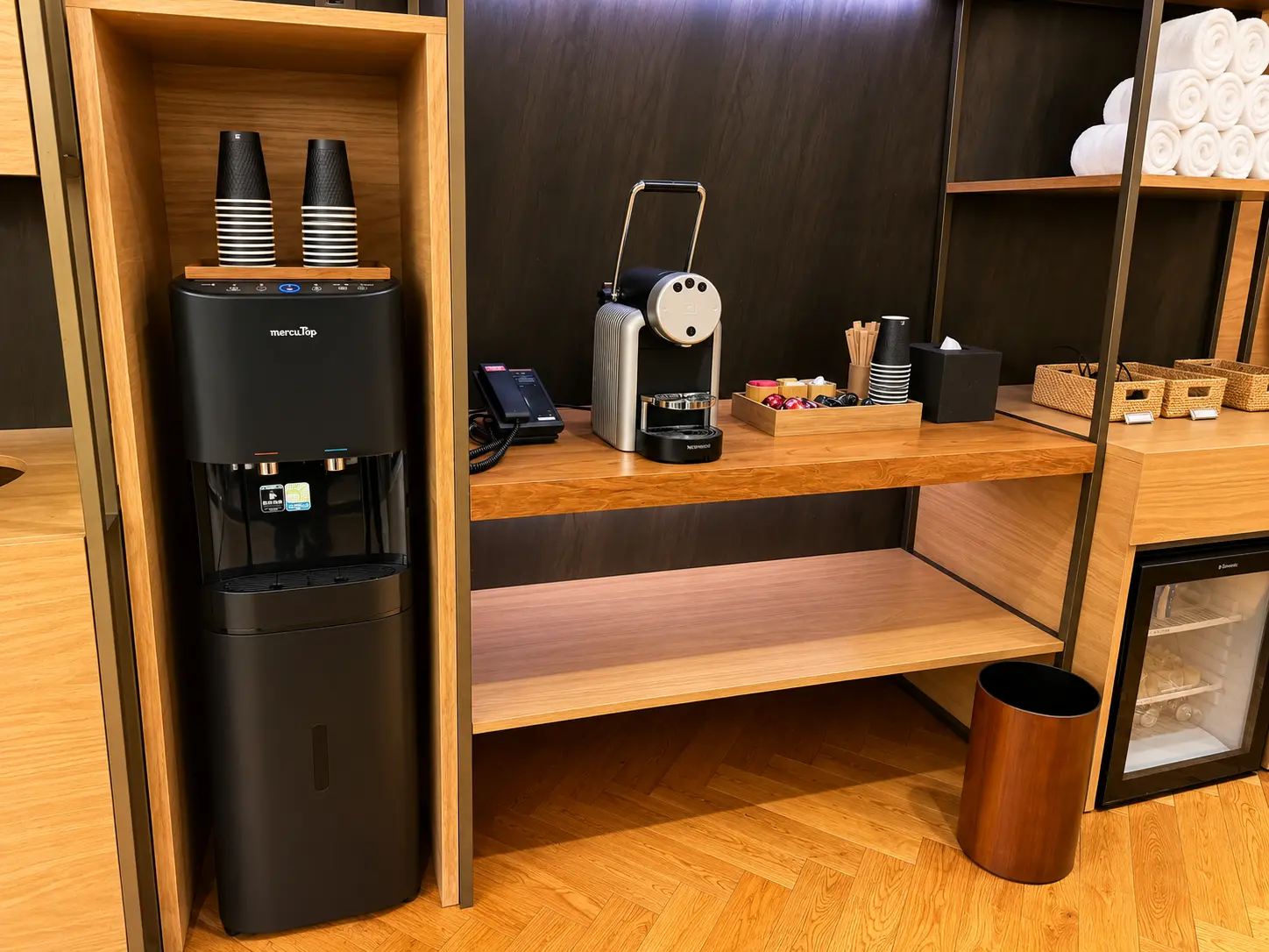 Coffee and filtered water station inside the fitness center at Four Seasons Hotel Kyoto with towels and refreshments.