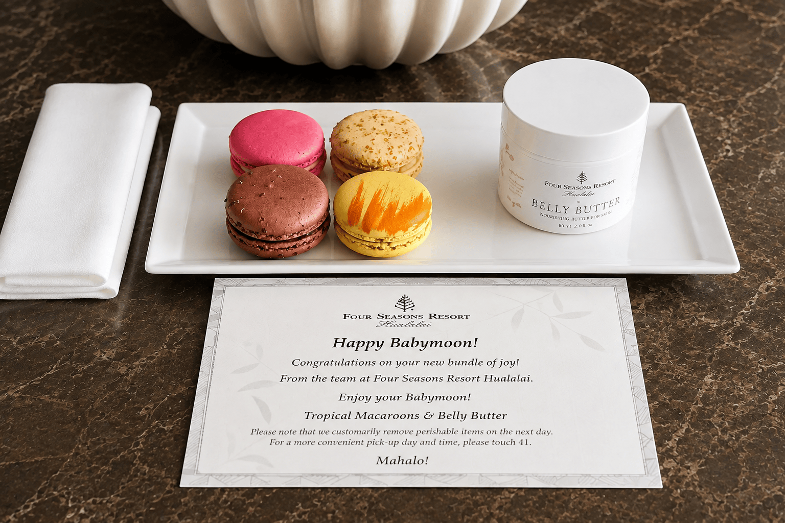 Four Seasons Resort Hualalai babymoon welcome amenity with macarons and belly butter