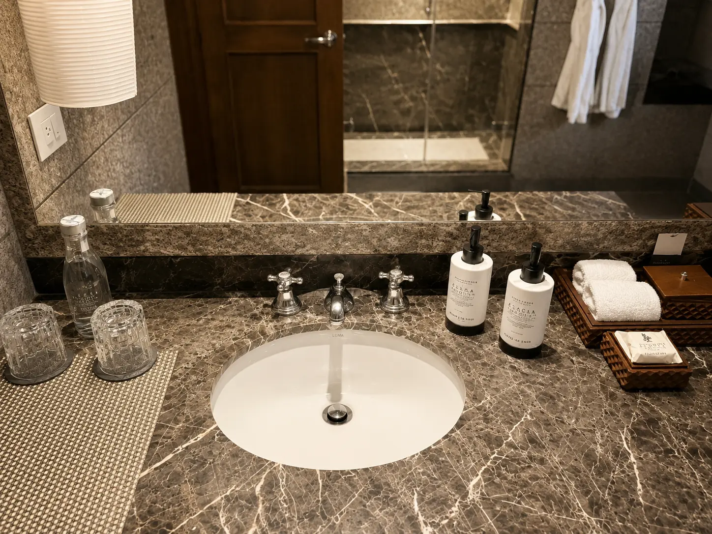 Marble bathroom vanity in an Executive Suite With Fireplace at Four Seasons Hotel Casa Medina Bogotá with chrome fittings and Casa Medina bath amenities.