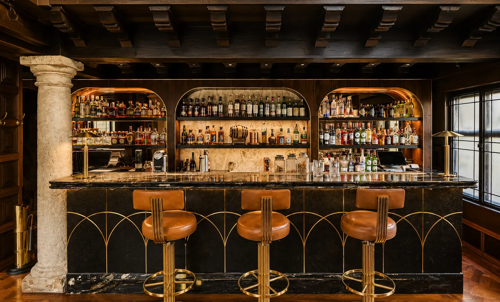 Castanyoles Bar at Four Seasons Hotel Casa Medina Bogotá with marble counter, spirit shelves, greenery and bar seating.