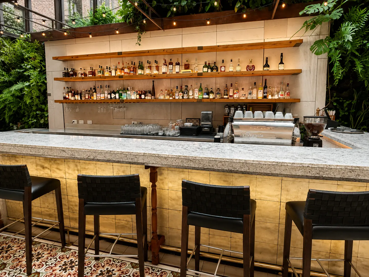 Castanyoles Bar at Four Seasons Hotel Casa Medina Bogotá with marble bar, spirits display and tropical greenery