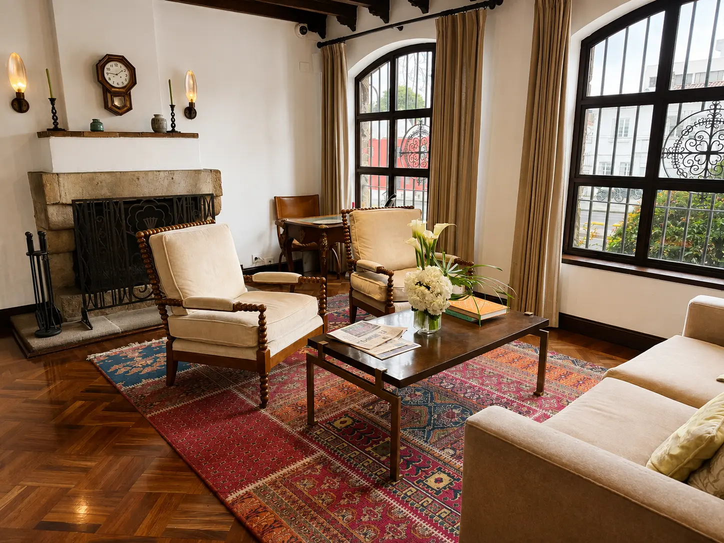 Fireplace lounge at Four Seasons Hotel Casa Medina Bogotá with stone walls, patterned tile floors and dark woven seating. 
